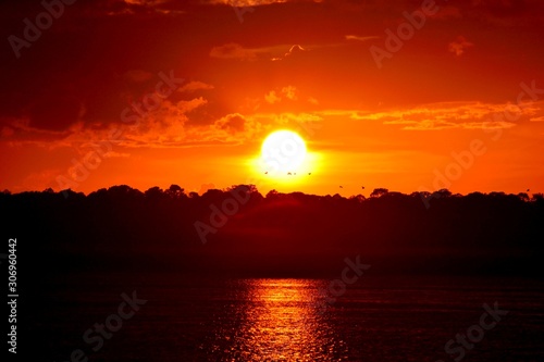 Vibrant sunset over the river at North Beach  Florida with birds  in background