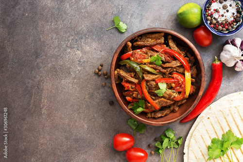 Tableau sur toile Mexican food fajitas and salsa sauce on a dark rustic background