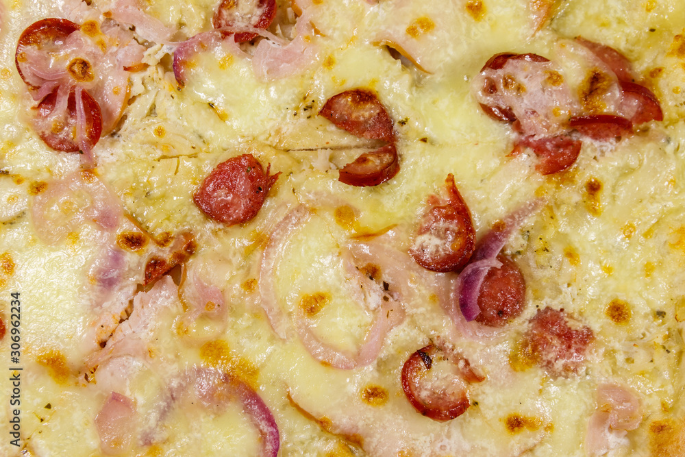Texture of a delicious fresh pizza with sausage, red onion and cheese Texture of a delicious fresh pizza with sausage, red onion and cheese