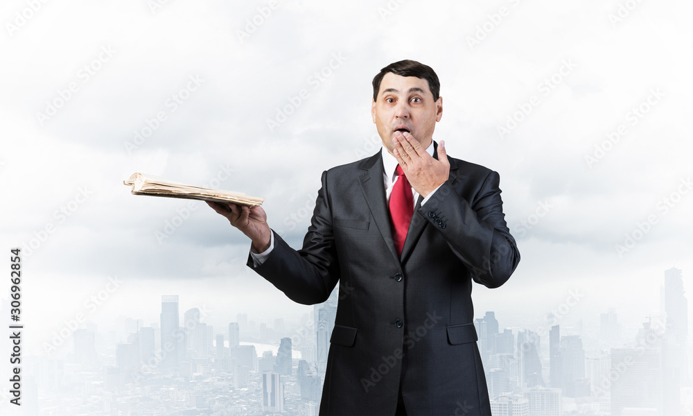 Embarrassed businessman covering mouth with hand Embarrassed businessman covering mouth with hand