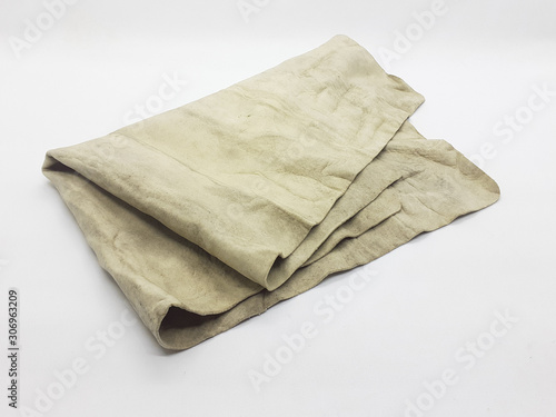 Reusable Yellow Used Dirty Industrial Kanebo Rubber Cleaning Cloth in White Isolated Background