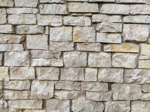 Stone rock brick tiles stacked and making an interesting natural looking facade wall for exterior of a building or house