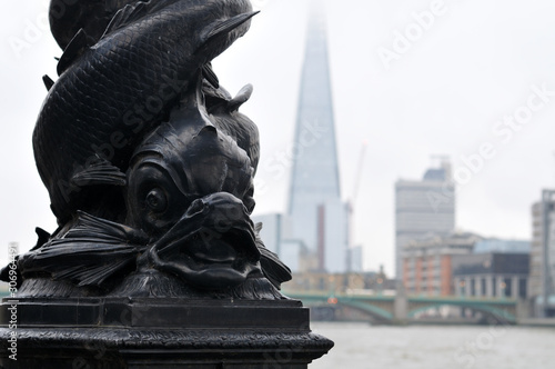detail of a cast iron lamp post with fantasy fish