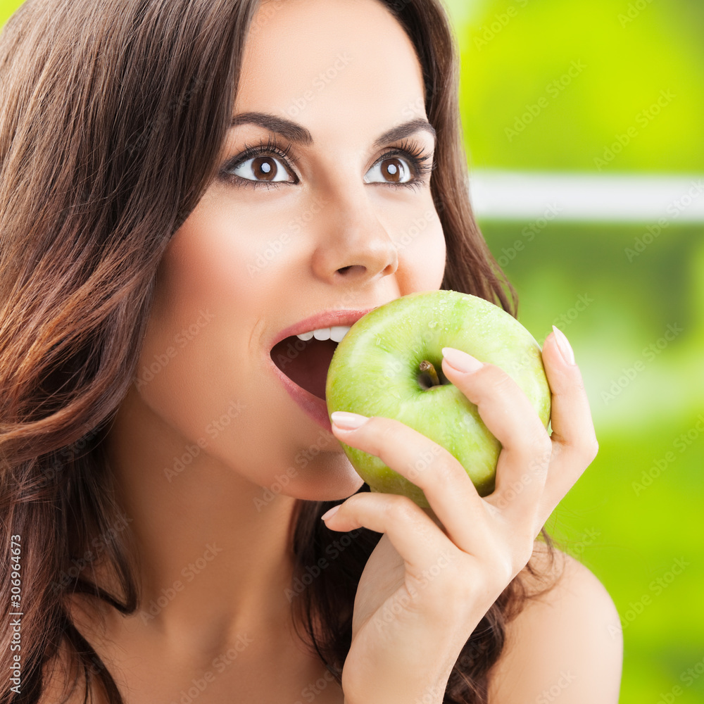 Young happy smiling lovely brunette woman with green apple Young happy smiling lovely brunette woman with green apple
