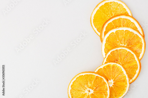 Eco organic homemade dried orange slices, chips. Dehydrated crispy fruit slices. Heap, pile of sun dried crunchy oranges. Healthy snack. Close up. Top view. Copy space