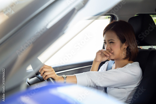 Фотография Young Asian woman hold her nose because of bad smell dirty in car