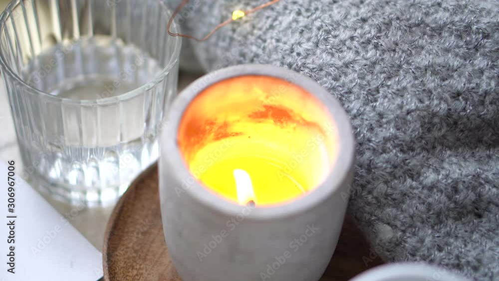 Burning candle in concrete can on table Burning candle in concrete can on table