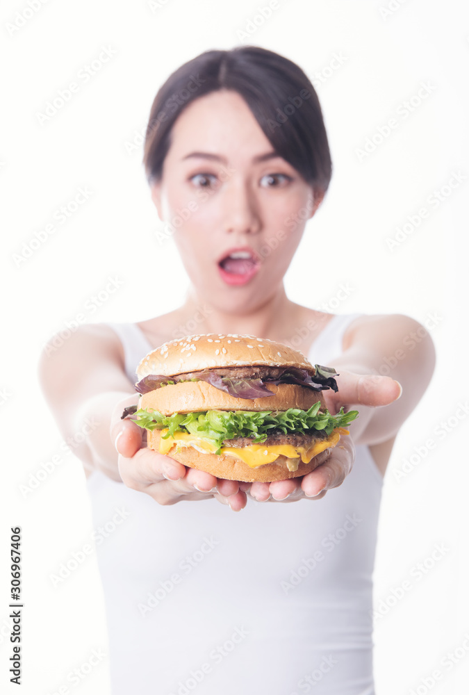 young asia woman standing isolated eating a burger