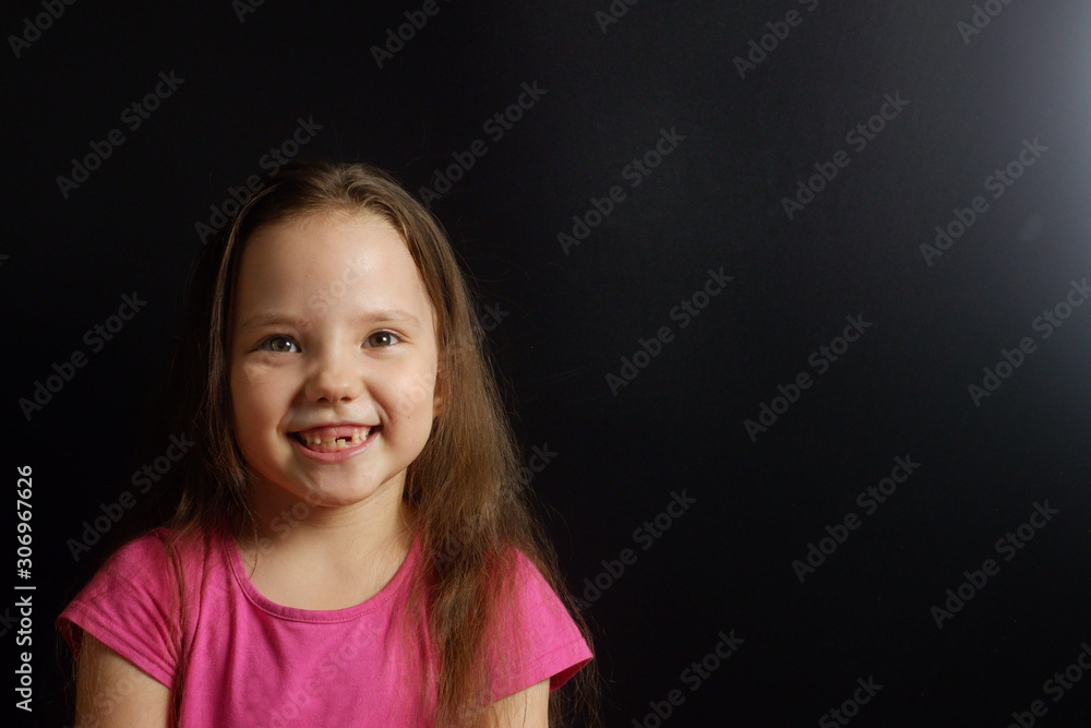 Portrait of a charming happy laughing girl with fallen baby teeth Portrait of a charming happy laughing girl with fallen baby teeth