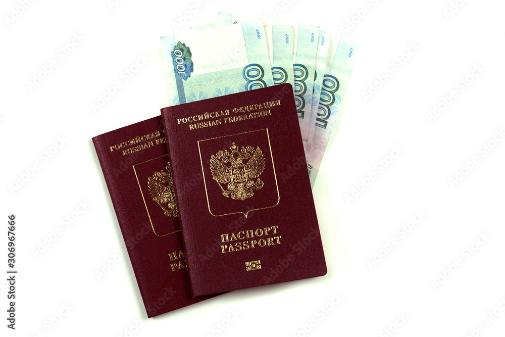 Two Russian passports with a pack of one thousand rubles. The concept of immigration, tourism, travel to the resort. Purchase or pledge, a large amount of rubles. Isolated. Two Russian passports with a pack of one thousand rubles. The concept of immigration, tourism, travel to the resort. Purchase or pledge, a large amount of rubles. Isolated.