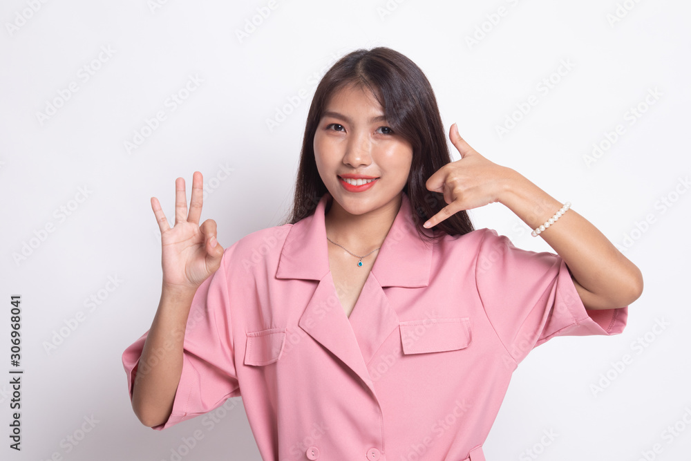 Young Asian woman show with phone gesture and OK sign.