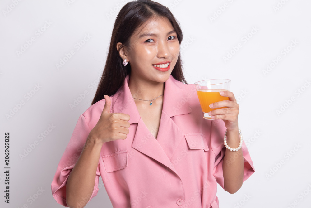 Young Asian woman thumbs up drink orange juice. Young Asian woman thumbs up drink orange juice.
