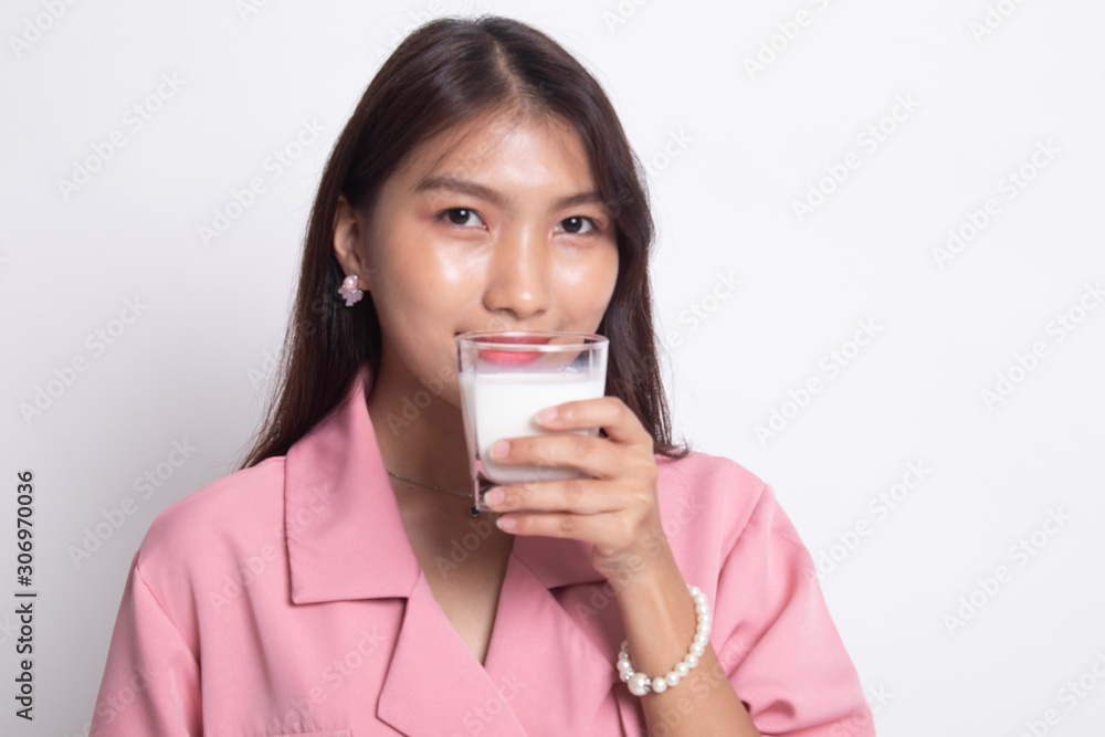 Healthy Asian woman drinking a glass of milk. Healthy Asian woman drinking a glass of milk.