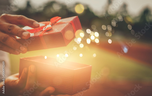 He opened a wonderful gift box for his lover.Concept merry christmas and happy new year 2022 , 2023, 2024