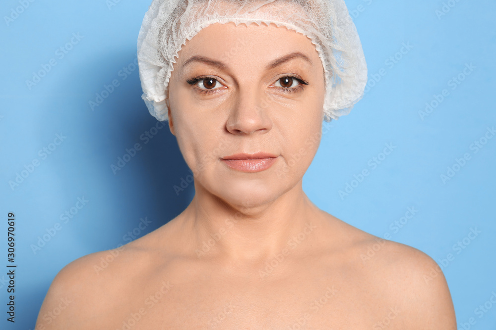 Mature woman with double chin on blue background Mature woman with double chin on blue background