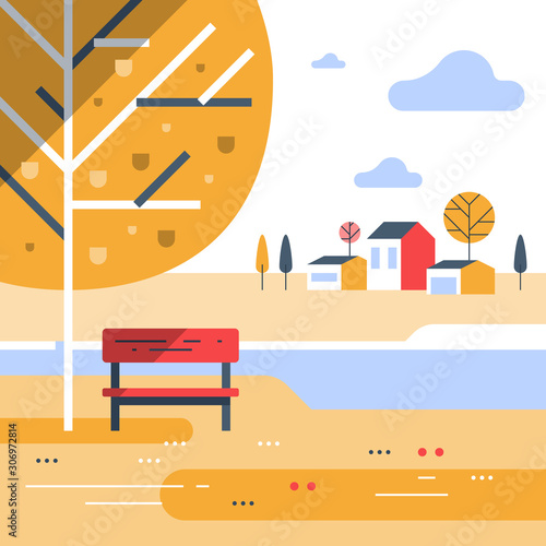 Autumn park scene, small bench at river bank, beautiful view, group of residential houses in background