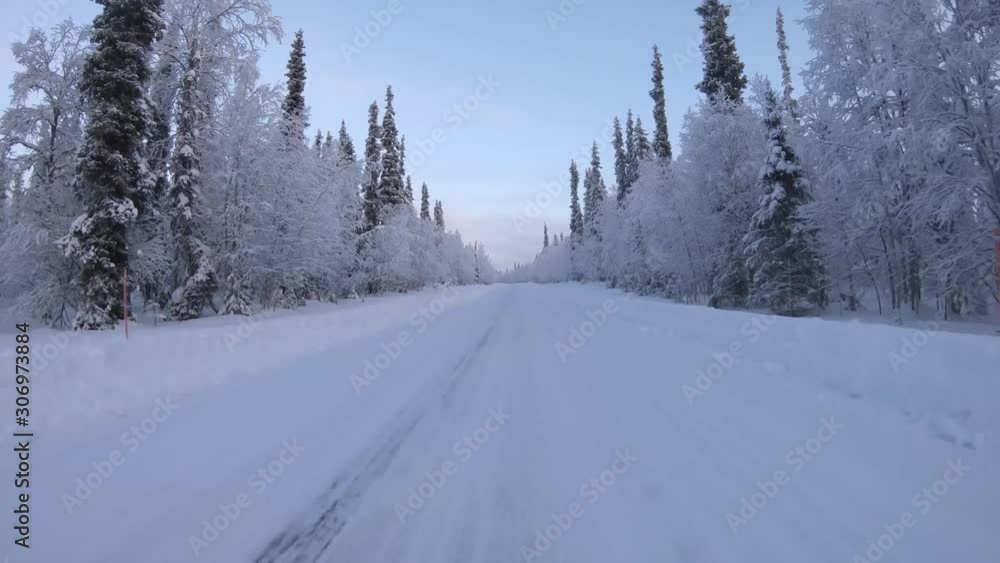 Point of view angle of driving on snowy road in winter forest Point of view angle of driving on snowy road in winter forest