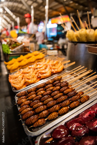 Grill and fried silkworm pupae in a food market in Beijing, China. photo