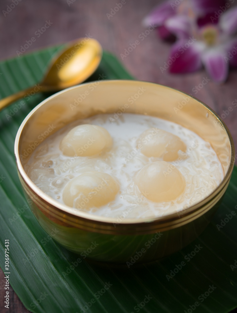 Sweet Sticky Rice with Longan and coconut milk on wood,Thai dessert Sweet Sticky Rice with Longan and coconut milk on wood,Thai dessert