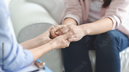 Doctor  psychologist  therapist holding female patient hands