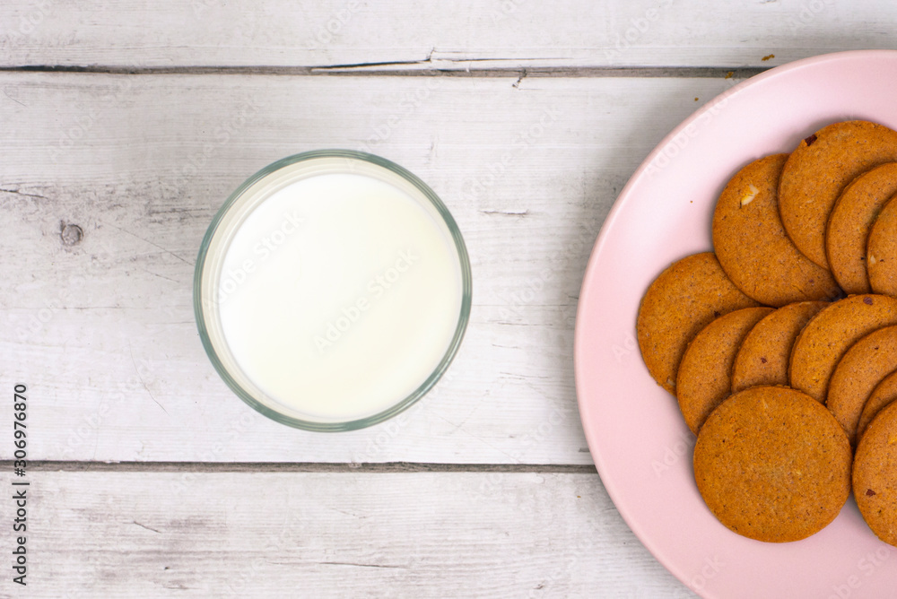 Glass of milk and cookies on the table close-up.