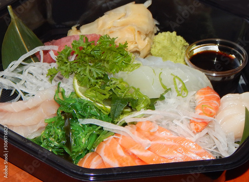 Delicious sashimi to go with fresh raw fish, alga, vegetables and spices