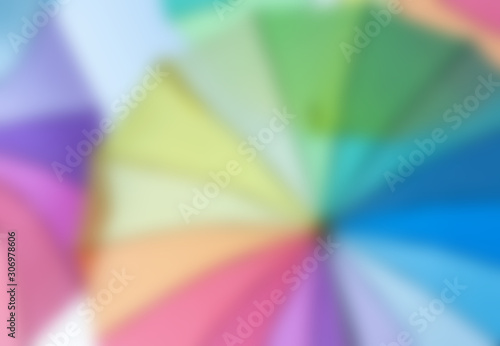 out of focus background image of rainbow coloured umbrellas