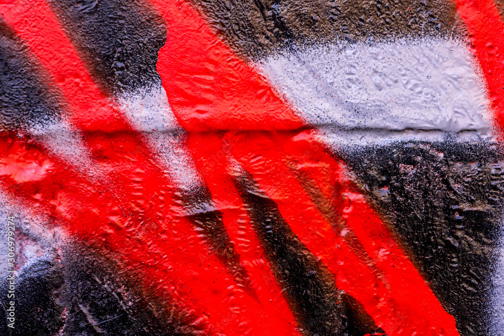 Obraz premium Beautiful bright colorful street art graffiti background. Abstract creative spray drawing fashion colors on the walls of the city. Urban Culture, black , red , white , blue, purple texture