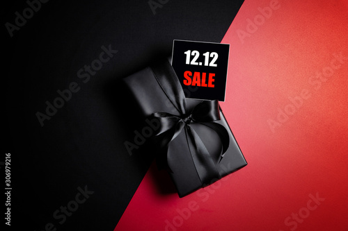 Top view of black gift box with black background with copy space for text 12.12 singles day sale.