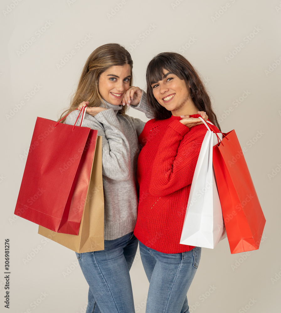 Two beautiful girl friends with shopping bags feeling overjoy and happiness Two beautiful girl friends with shopping bags feeling overjoy and happiness