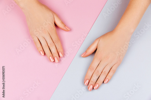 Beautiful Woman Hands on pink grey backgrounda. Spa and Manicure concept. Female hands with pink manicure. Soft skin skincare concept. Beauty nails.