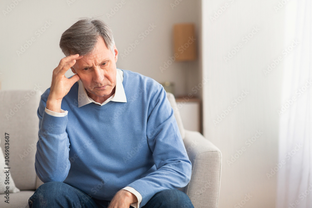 Elderly Man Thinking About Loneliness Sitting On Couch At Home Elderly Man Thinking About Loneliness Sitting On Couch At Home