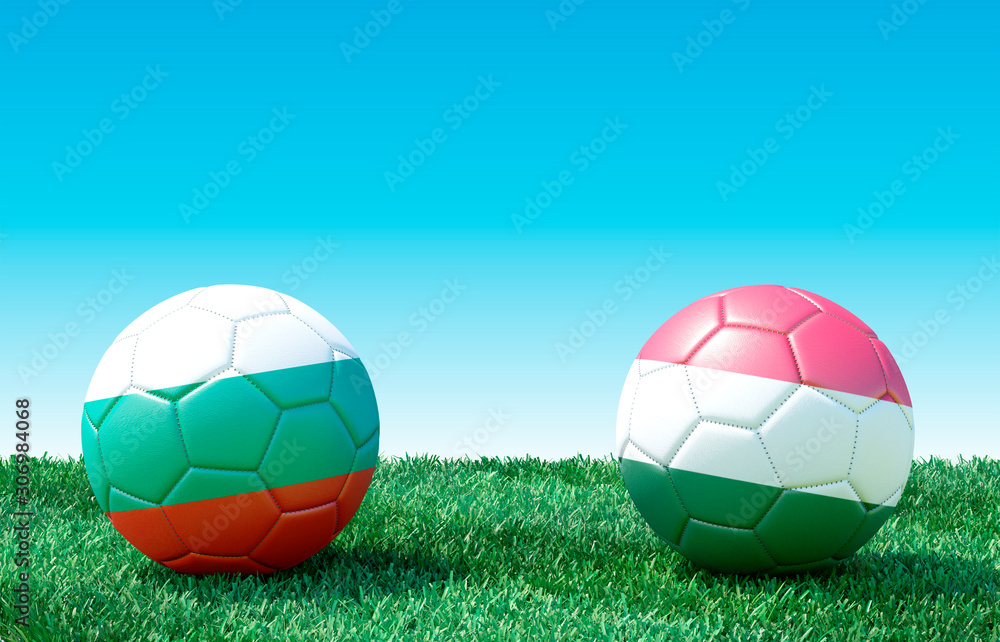 Fototapeta premium Two soccer balls in flags colors on green grass. Bulgaria and Hungary. 3d image