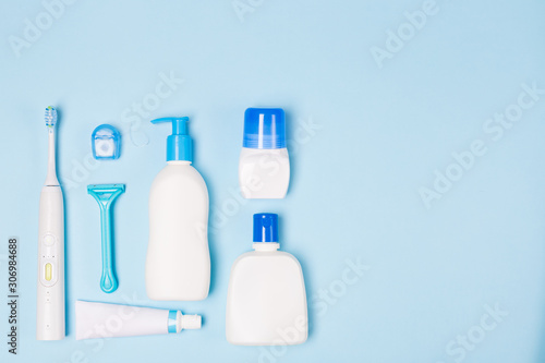 Woman Bath face cleaning care morning routine top view flat lay composition with white and blue items on light blue desk