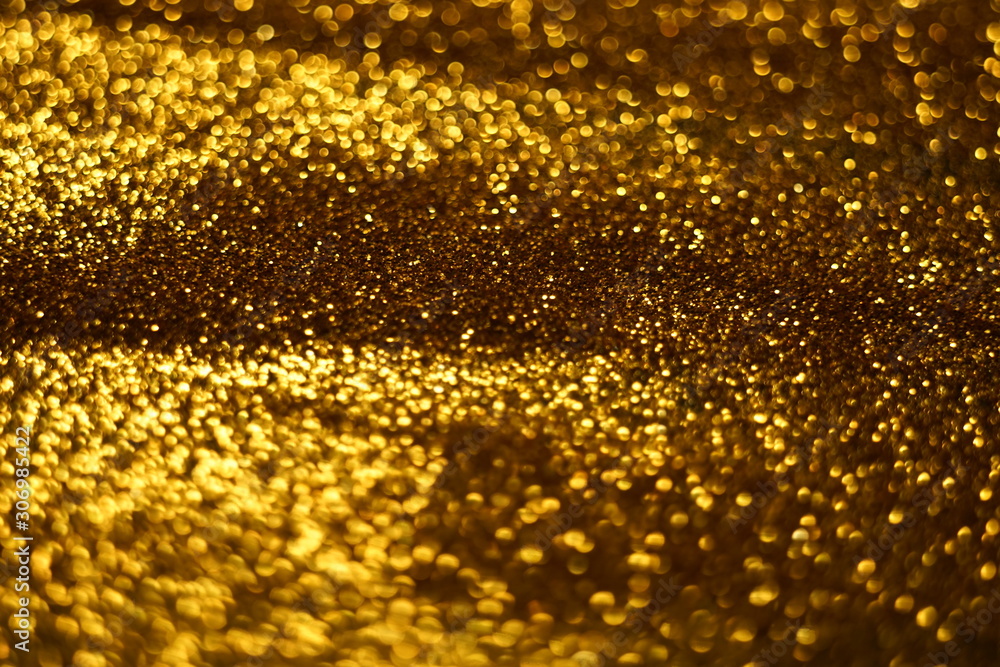 Golden glitter shiny background, gold sand blurry texture.