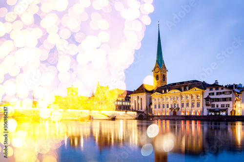 christmas lights and snow in Zurich city center with famous Fraumunster and Grossmunster Churches and river Limmat at Lake Zurich, Canton of Zurich, Switzerland