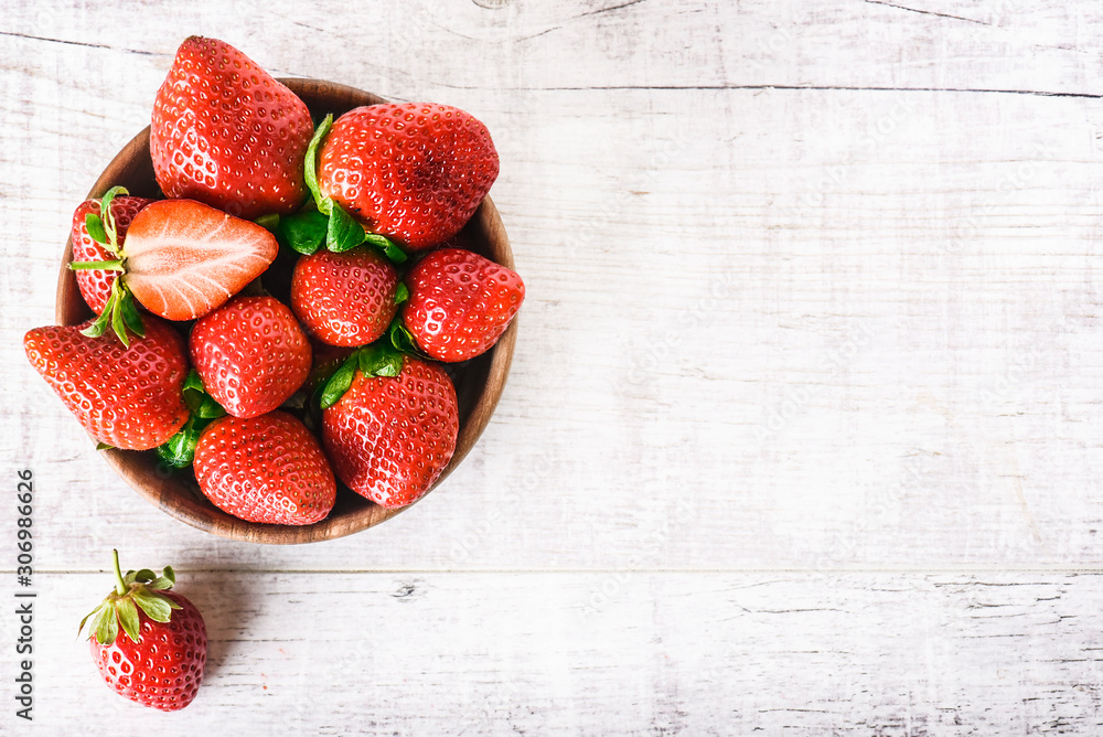 Ripe strawberries forest fruits in wooden bowl on white table. Fresh  strawberry top view. Stock Photo | Adobe Stock