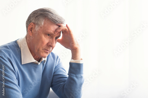 Depressed Senior Man Thinking About Problems Sitting At Home