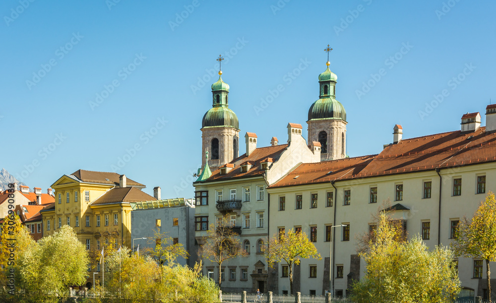 NNSBRUCK, AUSTRIA - October 26, 2019: View of the old palaces with the San Giacomo Cathedral towers on the Inn river bank - Innsbruck, Tyrol Austria