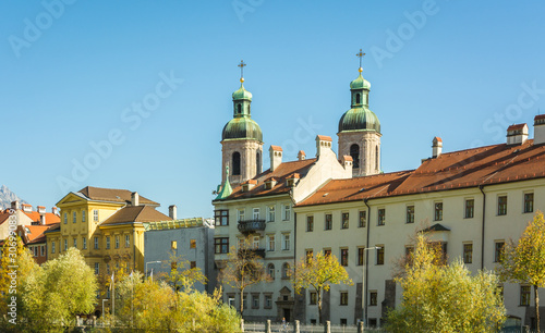 NNSBRUCK, AUSTRIA - October 26, 2019: View of the old palaces with the San Giacomo Cathedral towers on the Inn river bank - Innsbruck, Tyrol Austria photo