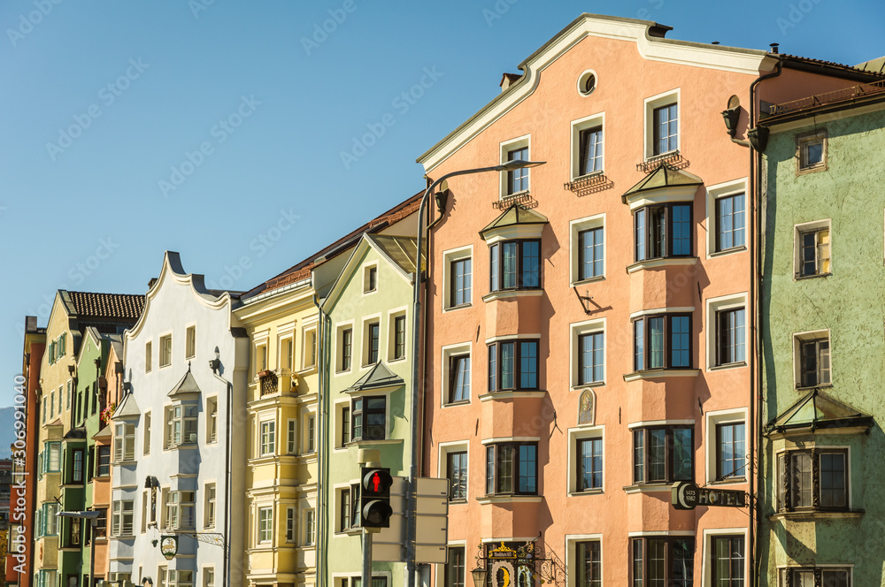 The ornate and colourful residential buildings in the famous Mariahilf district of Innsbruck town, Inn riveside, Austria, Europe.