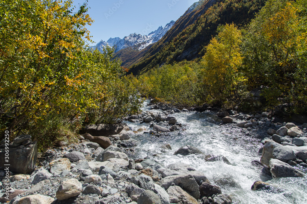 Dombay mountains, trekking in national park to the Alibek waterfall and glacier, autumn landscape