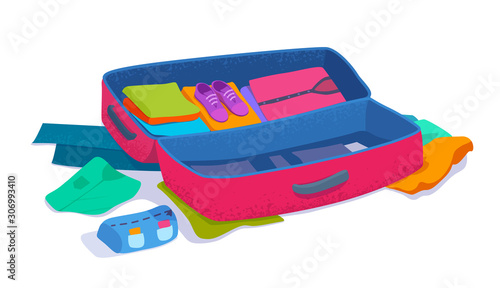 An open suitcase packed with things. Packing or unpacking of luggage with colorful clothes. 