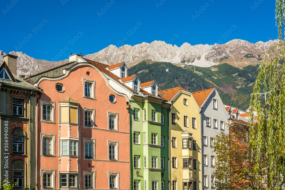 The ornate and colourful residential buildings in the famous Mariahilf district of Innsbruck town, Inn riveside, Austria, Europe.