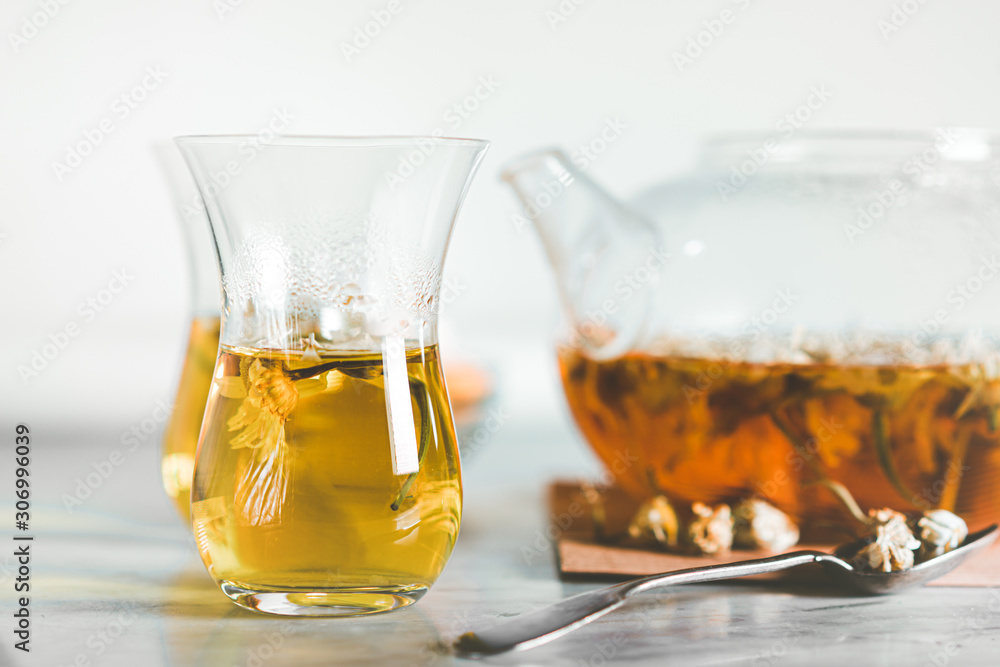 Cup and teapot filled with herbal tea Cup and teapot filled with herbal tea