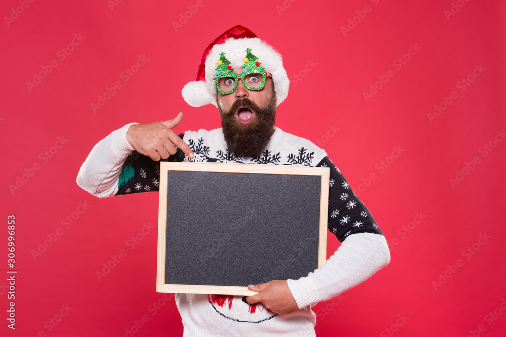 Let this surprise you. Surprised santa point finger at blackboard ...