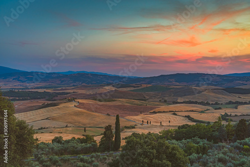 Beautiful sunset over the hills near Pienza. Travel destination Tuscany, Val d'Orcia, Italy
