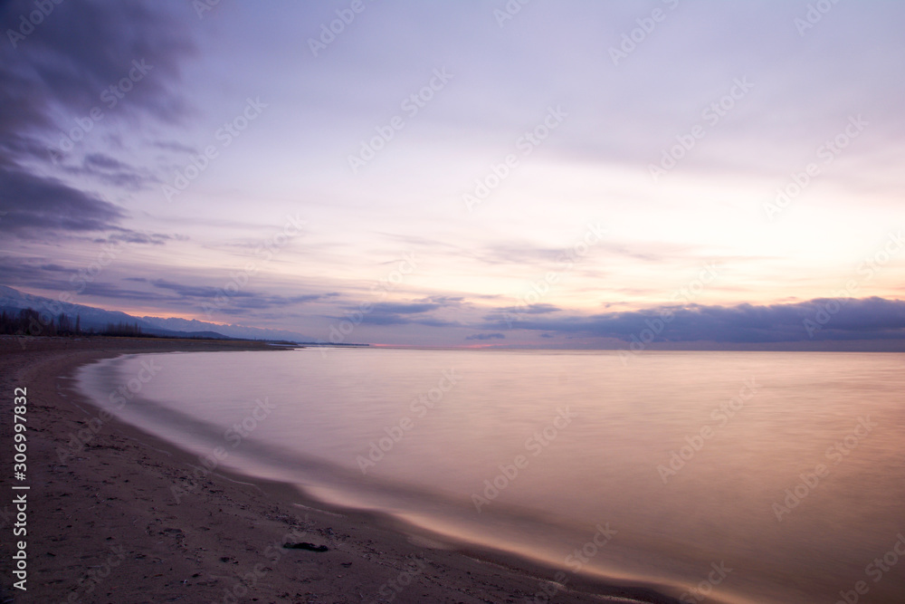 朝焼けのイシククル湖の浜辺