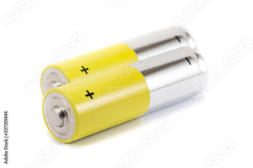 alkaline batteries and a yellow metal AA-size batteries isolated on white background closeup, carbon zinc batteries, rechargeable batteries, mockup