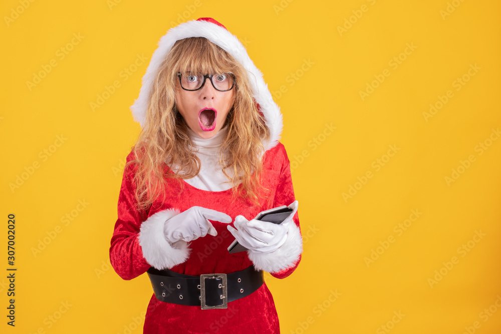 santa claus woman with mobile phone isolated on color background santa claus woman with mobile phone isolated on color background
